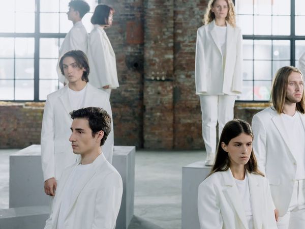 Group of diverse people sitting together in a bright studio.